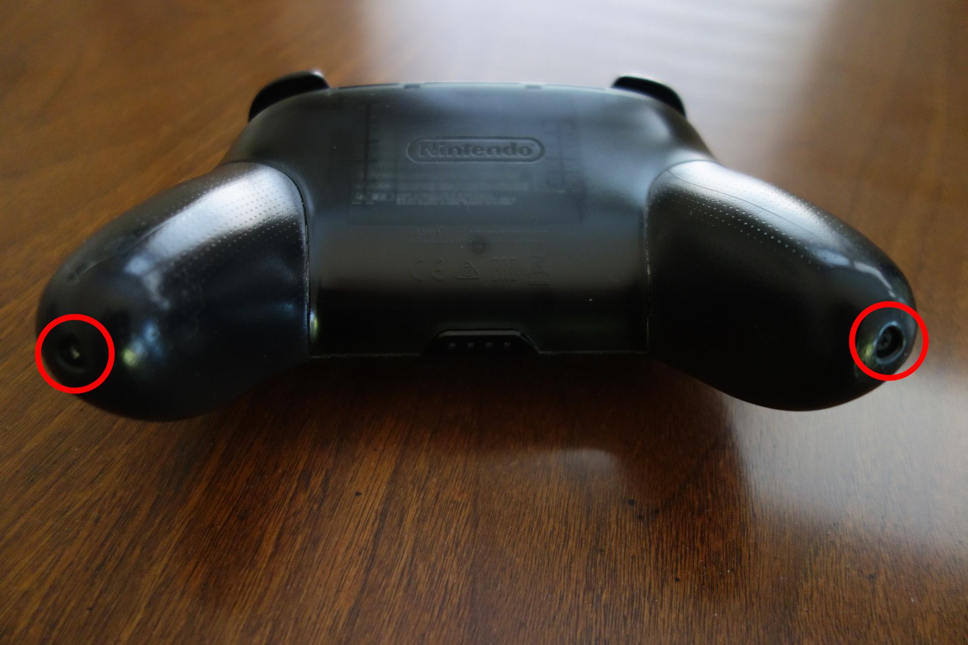 Image of pro controller with grip screws circled