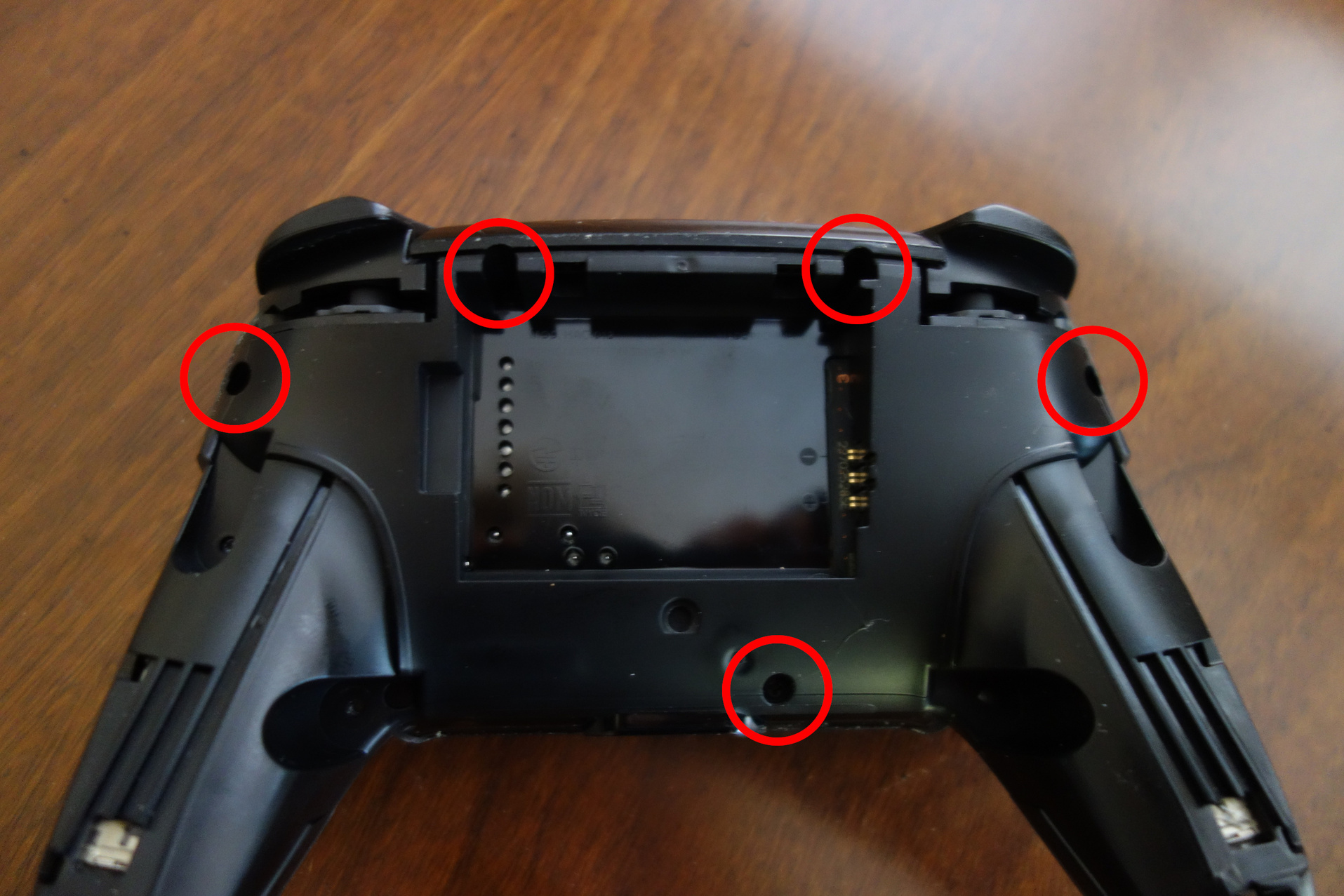 Image of controller with backplate removed and next screws circled